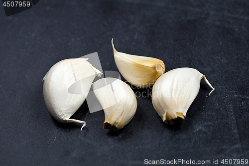 Image of Fresh raw organic garlic on black board.
