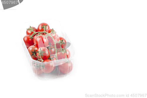 Image of Fresh organic cherry tomatoes bunch onplastic container isolated