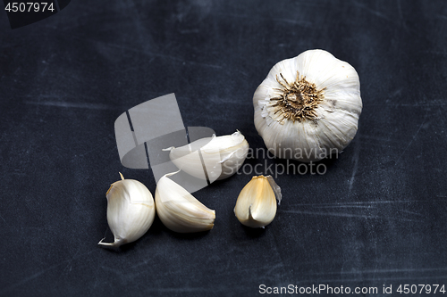 Image of Fresh raw organic garlic on black board.