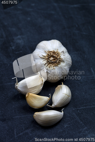 Image of Fresh raw organic garlic on black board.