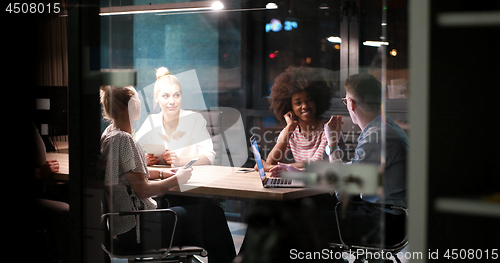 Image of Multiethnic startup business team in night office