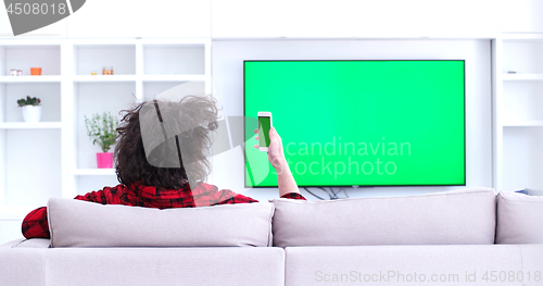 Image of Young couple on the sofa watching television