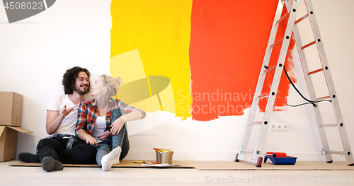 Image of Happy young couple relaxing after painting