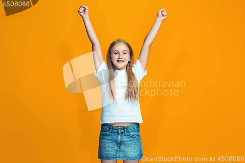 Image of Happy success teen girl celebrating being a winner. Dynamic energetic image of female model