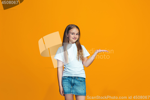 Image of Happy success teen girl presenting something