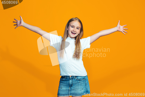 Image of Happy success teen girl celebrating being a winner. Dynamic energetic image of female model