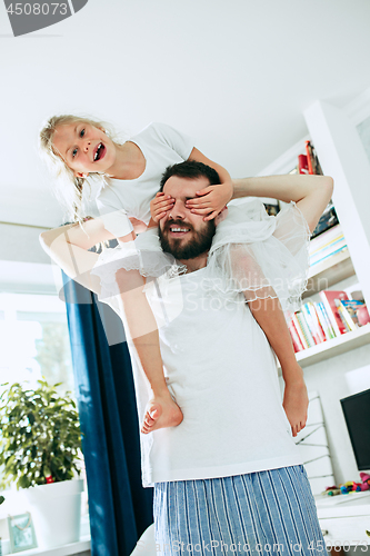 Image of Father and his six years kid girl at home