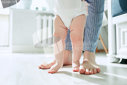 Image of father and his baby daughter at home