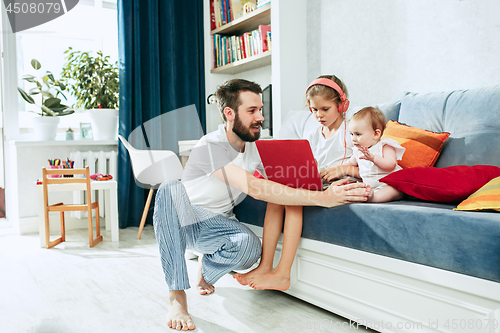 Image of father and his daughters at home