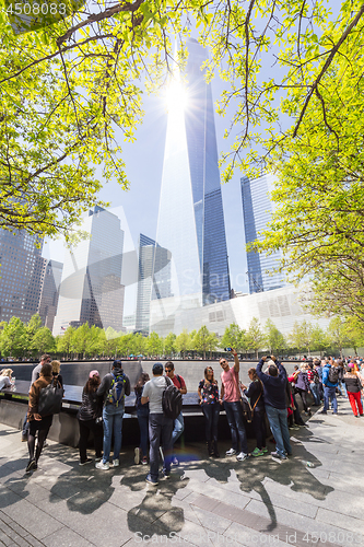 Image of Tourists visiting 9 11 memorial park in downtown Manhattan, located on the site as the original World Trade Center.