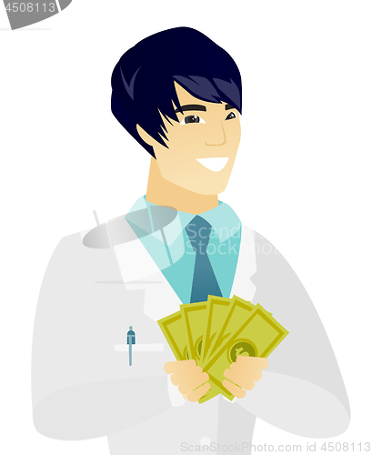 Image of Young asian doctor holding money.