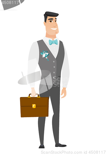 Image of Caucasian groom holding briefcase.