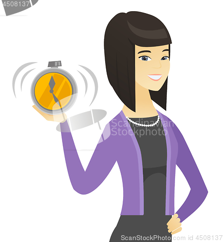 Image of Asian business woman holding alarm clock.