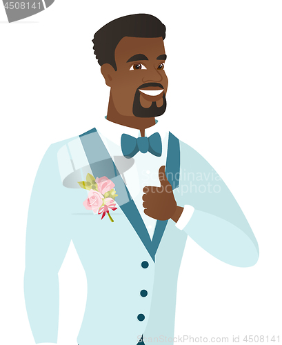 Image of Young african-american groom giving thumb up.