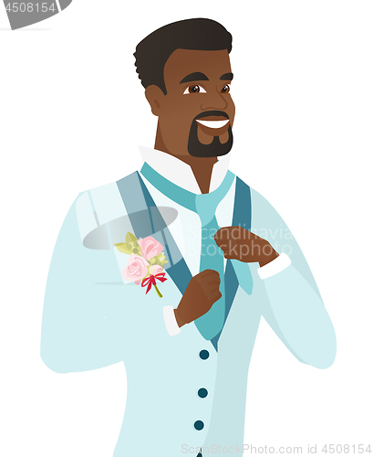 Image of Cheerful african-american groom adjusting tie.
