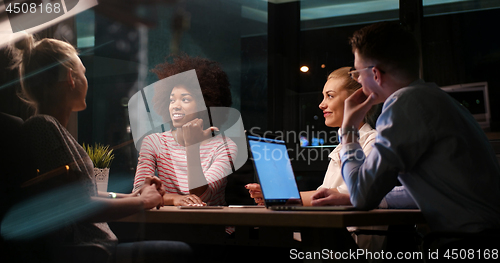 Image of Multiethnic startup business team in night office