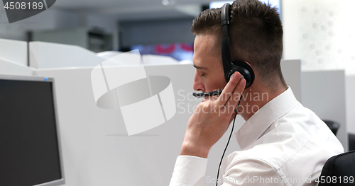 Image of male call centre operator doing his job