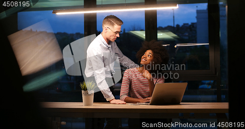 Image of Multiethnic startup business team in night office