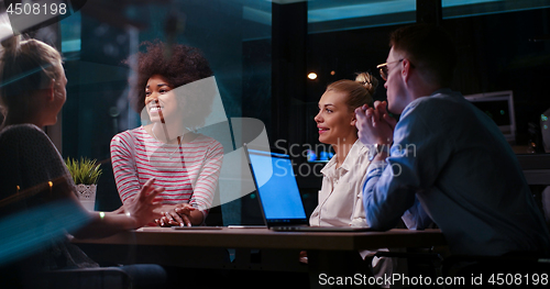 Image of Multiethnic startup business team in night office