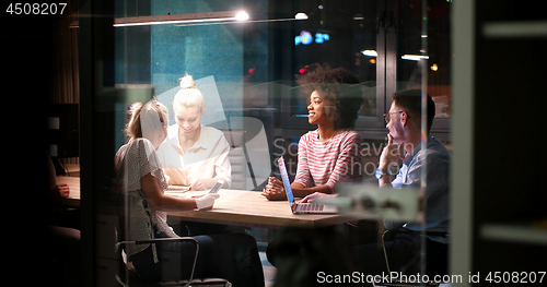 Image of Multiethnic startup business team in night office