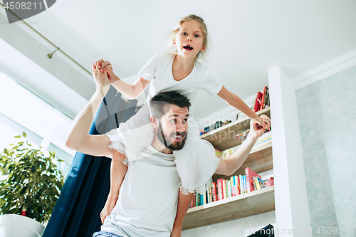 Image of Father and his six years kid girl at home