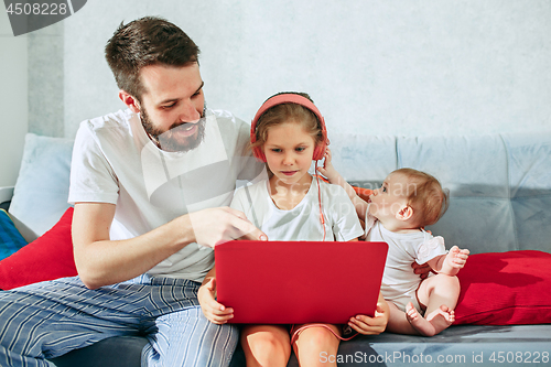 Image of father and his daughters at home