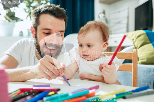 Image of father and his baby daughter at home