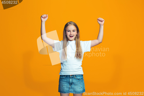 Image of Happy success teen girl celebrating being a winner. Dynamic energetic image of female model