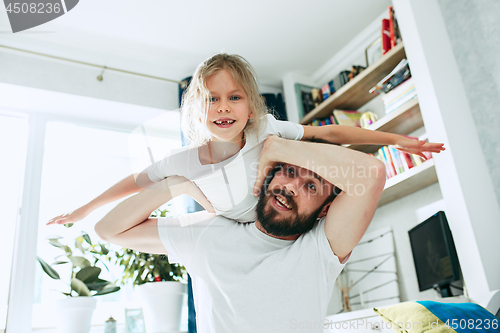 Image of Father and his six years kid girl at home