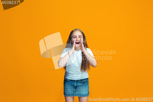 Image of Isolated on yellow young casual teen girl shouting at studio