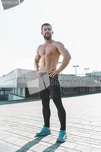 Image of Fit fitness man posing at city