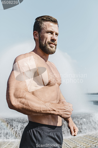 Image of Fit fitness man posing at city