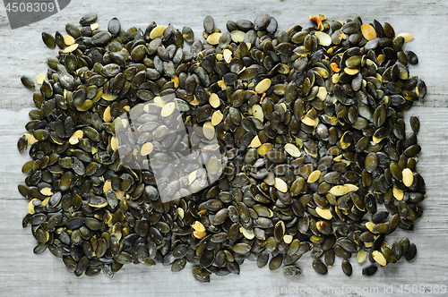 Image of pumpkeen seeds scattered over stone board