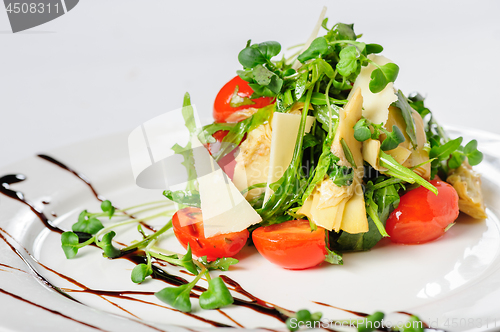 Image of salad with artichoke on the white plate