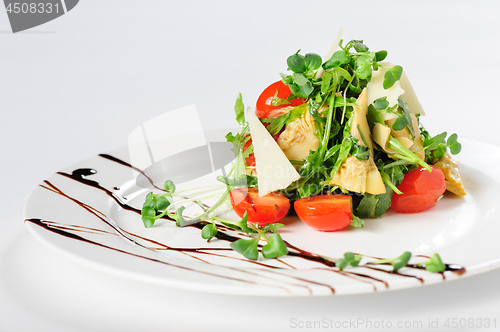 Image of salad with artichoke on the white plate