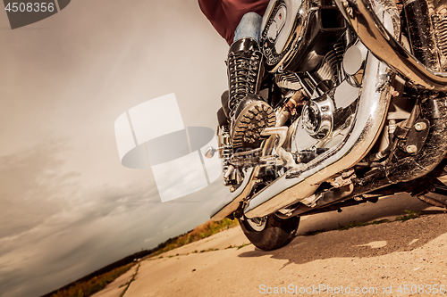 Image of Biker girl riding on a motorcycle