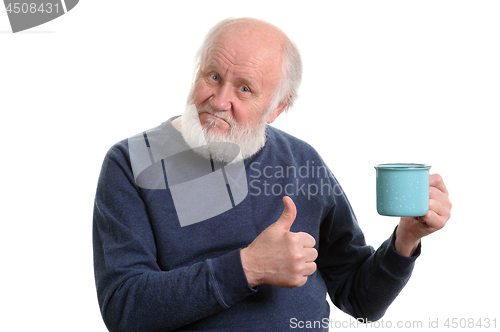 Image of elderly man with cup of bad tea or coffee showing thumb up isolated on white