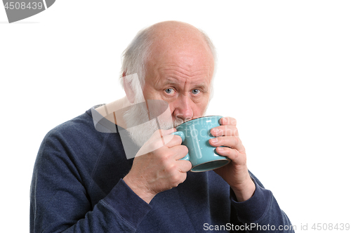 Image of Elderly man drinking from mug, isolated on white