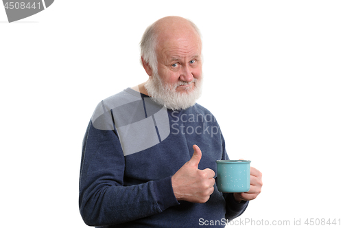 Image of elderly man with cup of bad tea or coffee showing thumb up isolated on white