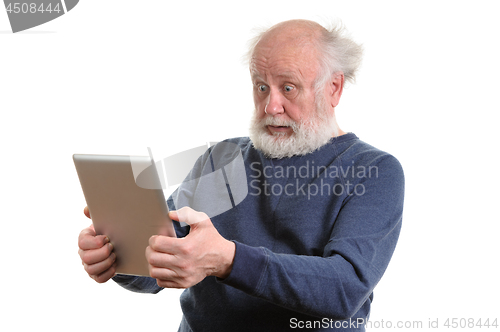 Image of Funny shocked senior man using tablet computer isolated on white