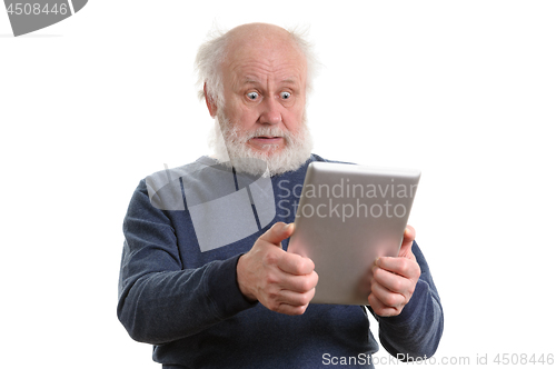 Image of Funny shocked senior man using tablet computer isolated on white
