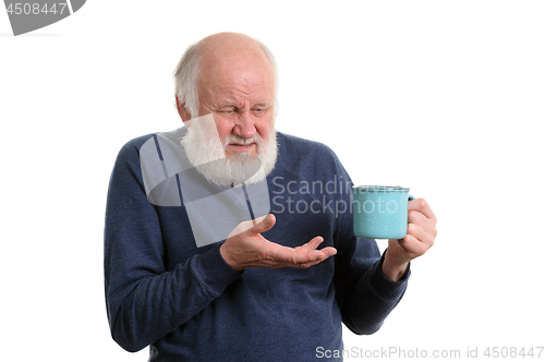 Image of unhappy elderly man with cup of bad tea or coffee isolated on white