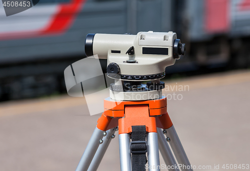 Image of Geodetic equipment optical level mounted on tripod at the railwa