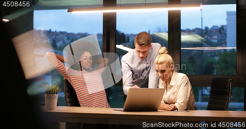 Image of Multiethnic startup business team in night office