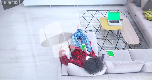 Image of Young couple on the sofa watching television