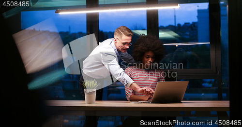 Image of Multiethnic startup business team in night office