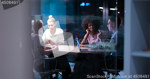 Image of Multiethnic startup business team in night office
