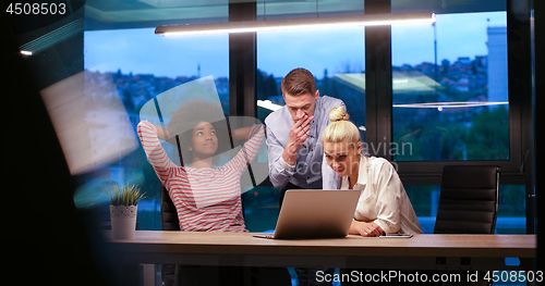 Image of Multiethnic startup business team in night office