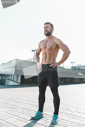 Image of Fit fitness man posing at city