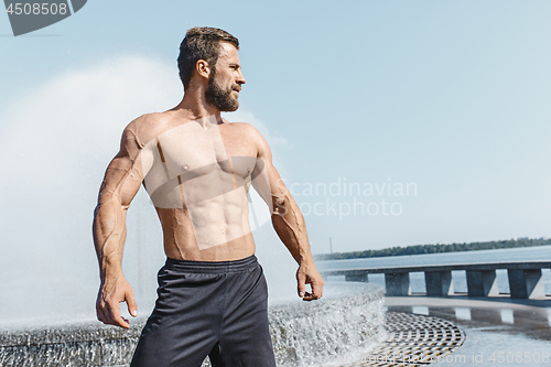 Image of Fit fitness man posing at city